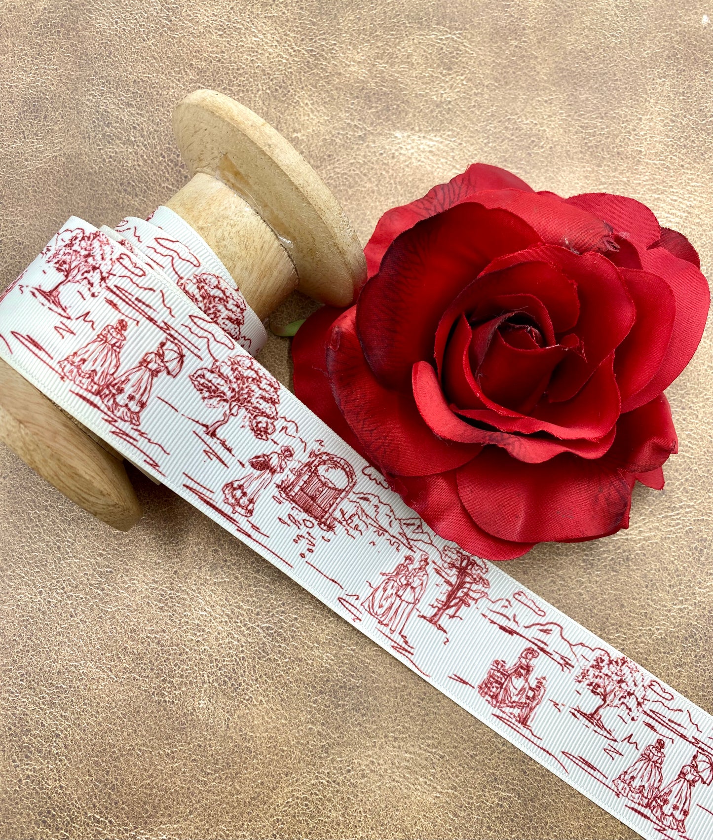 French Toile Ribbon in red , black and blue with a pastoral scene of a couple strolling in a park printed on 1.5" antique white grosgrain