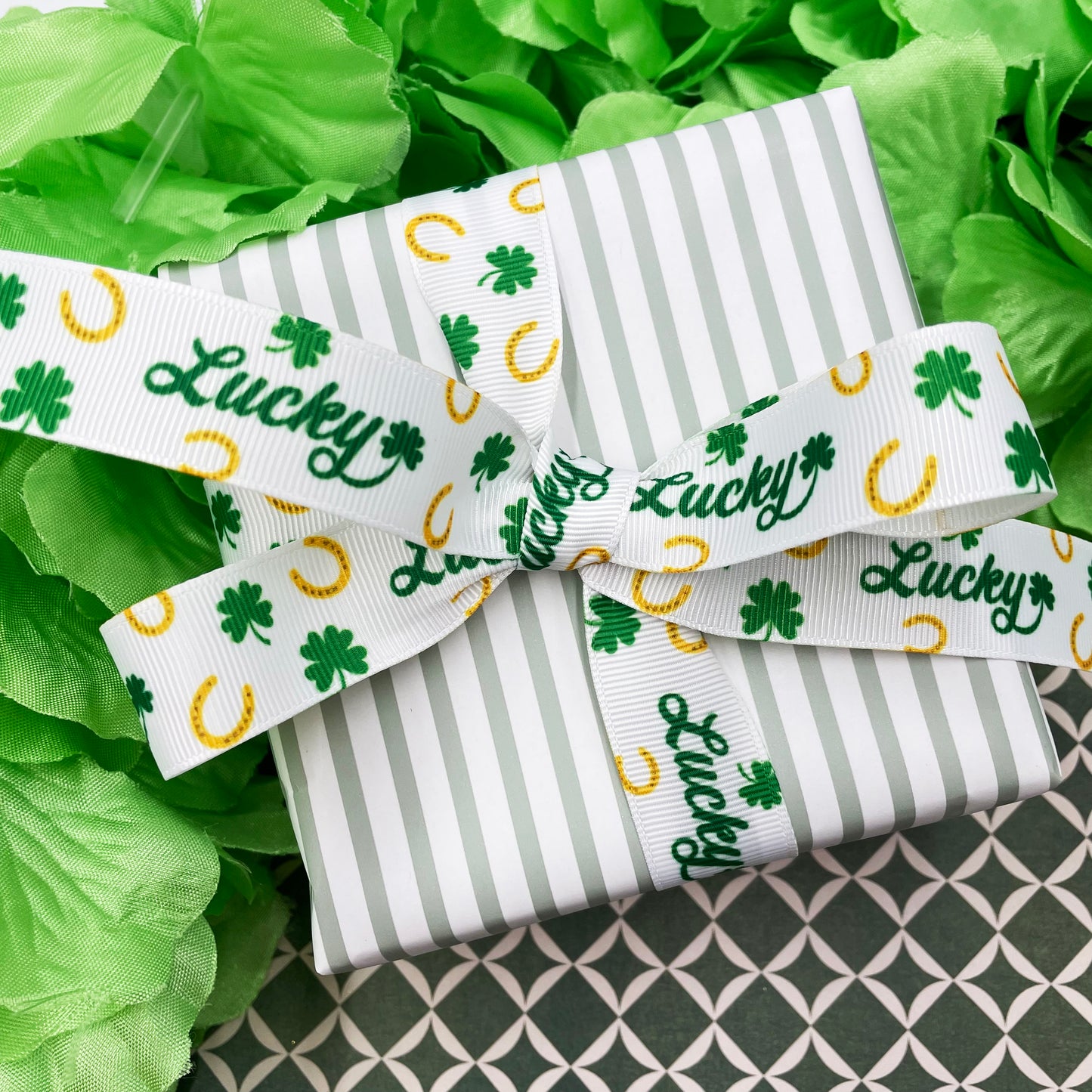 Lucky ribbon for St Patrick's Day  and Equestrian events with horse shoes and tossed shamrocks printed on 7/8" white satin and grosgrain