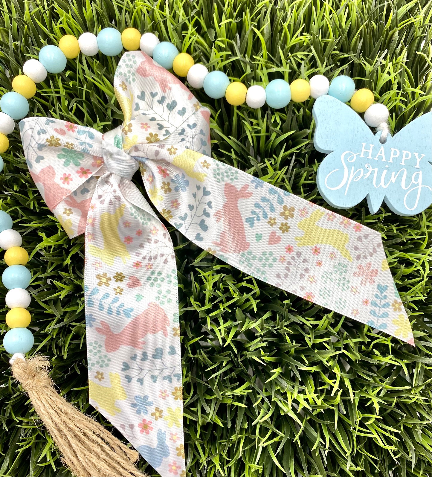 Easter ribbon pastel bunnies hopping in the flora in Spring shades of yellow, pink and blue printed on 7/8" and 1.5"  white satin