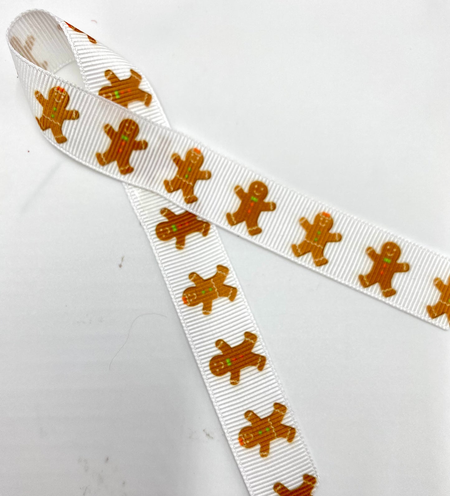Gingerbread Men Ribbon Gingerbread cookies with green and red bows printed on 5/8" white satin and grosgrain