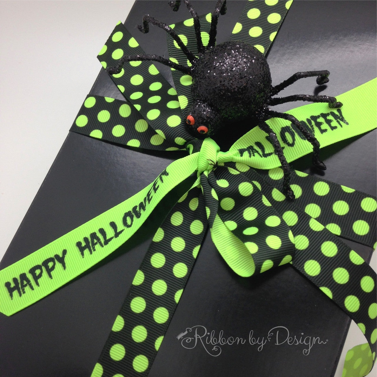 A Halloween gift box with a mix of neon green dots and Happy Halloween in neon green and black will make the recipient smile!