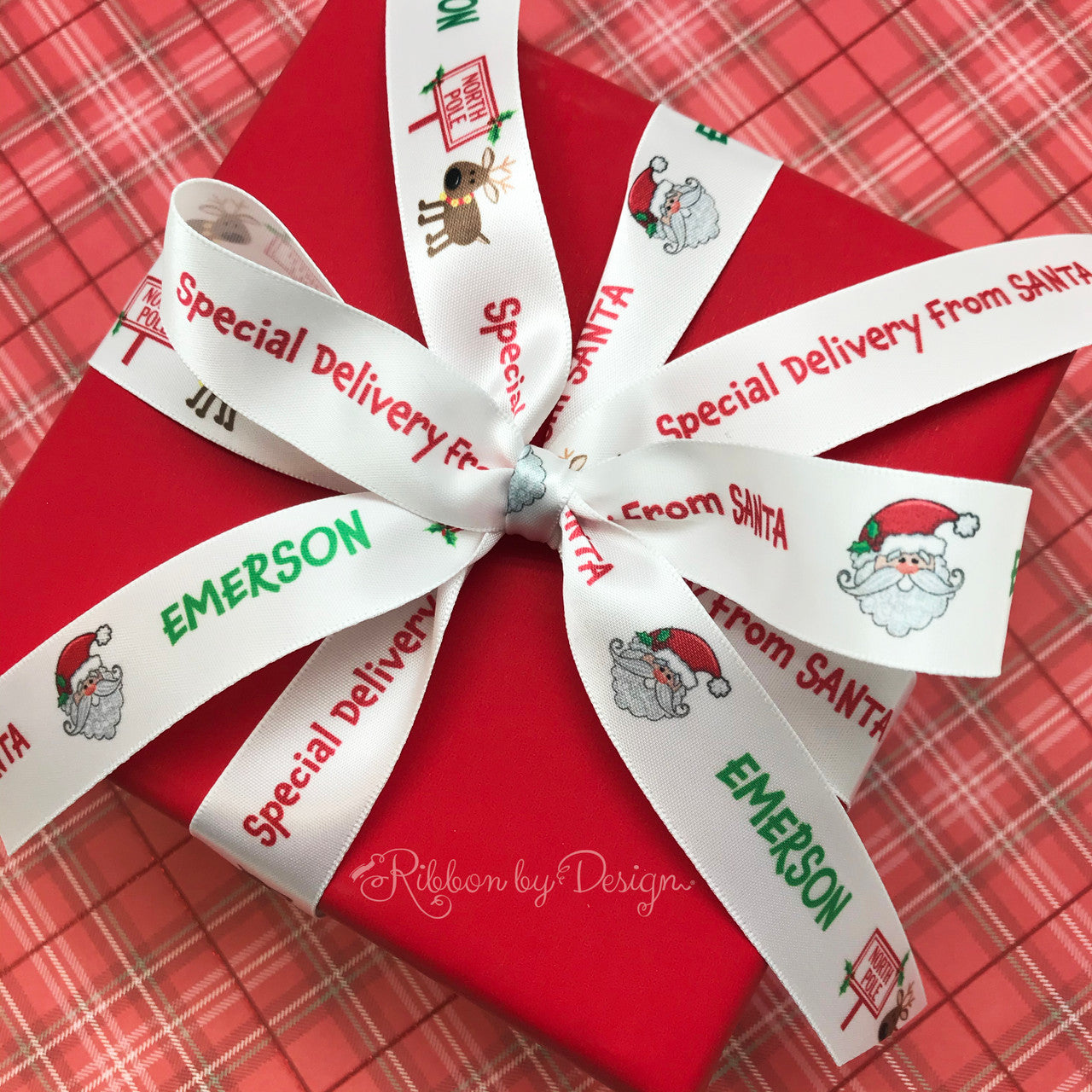 Personalized ribbon featuring any child's name with Special Delivery from Santa along with Santa's Face, a reindeer and North Pole sign printed on 7/8" white single face satin  will make Christmas morning even more magical for those who truly believe!  Make this ribbon part of any child's magical moment! All our ribbon is designed and printed in the USA