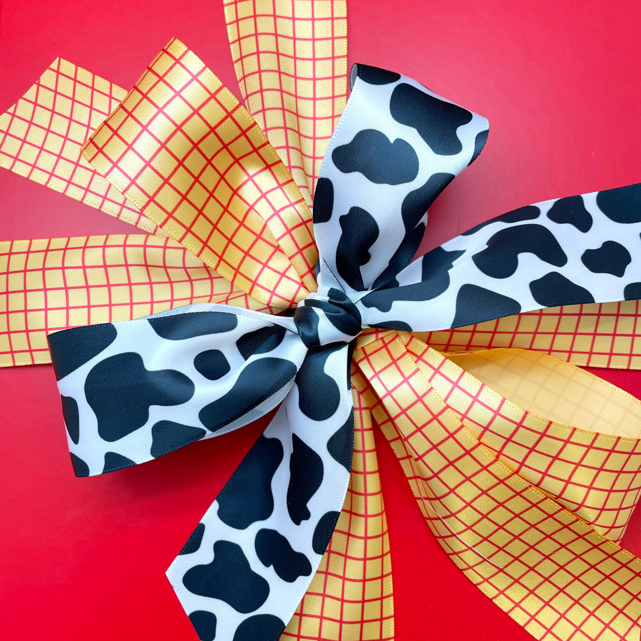 Cow print ribbon in black and white printed on 5/8", 7/8" and 1.5" white  satin