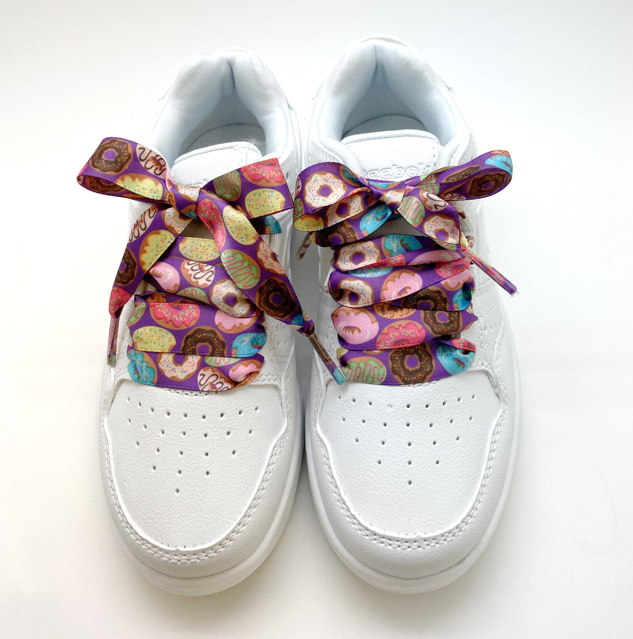 Satin shoelaces donut design is perfect for adding some fun and fashion to your sneakers! This is a great shoelace for fun dance shoes, wedding shoes, cheerleading and recitals! All our ribbon shoelaces are printed using dye sublimation technology and can be washed, ironed and re-used! All our laces are designed and printed in the USA