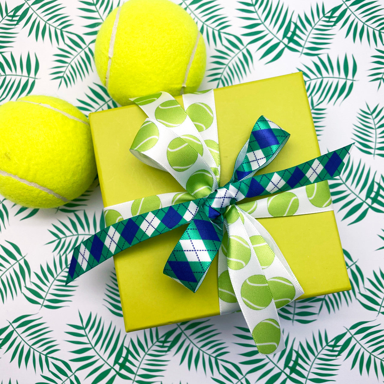 Tennis Ribbon green tennis balls bounce along on a white background printed on 5/8" single face satin