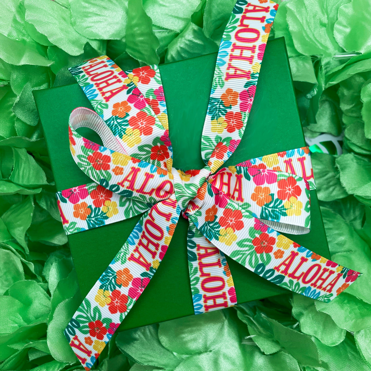 Aloha ribbon with tropical flowers of orange, pink, yellow and