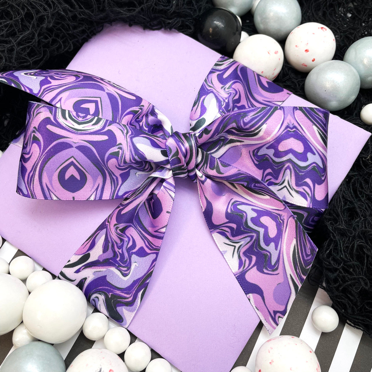 Tie a beautiful satin bow in a gift large or small with our marbled ribbon to make a big impact!