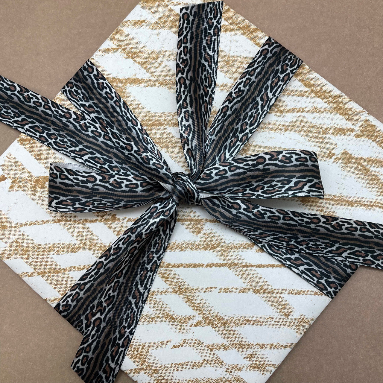 Ocelot pattern ribbon printed in shades of brown, black and gray tied on any gift makes for a beautiful presentation! 