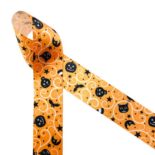 Vintage Halloween ribbon featuring black cats, jack o'lanterns, bats, stars and moons printed on an orange background with cream swirls on white satin