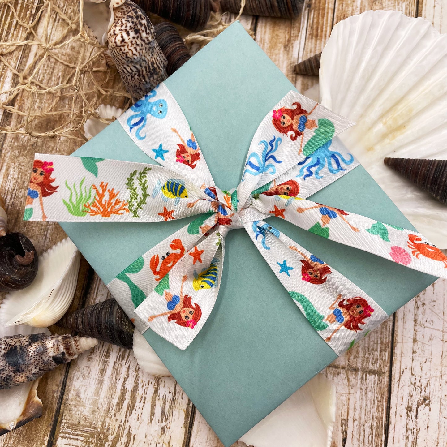 Tie our lovely Mermaid ribbon on white on a gift package to make a lovely Under the Sea themed gift!