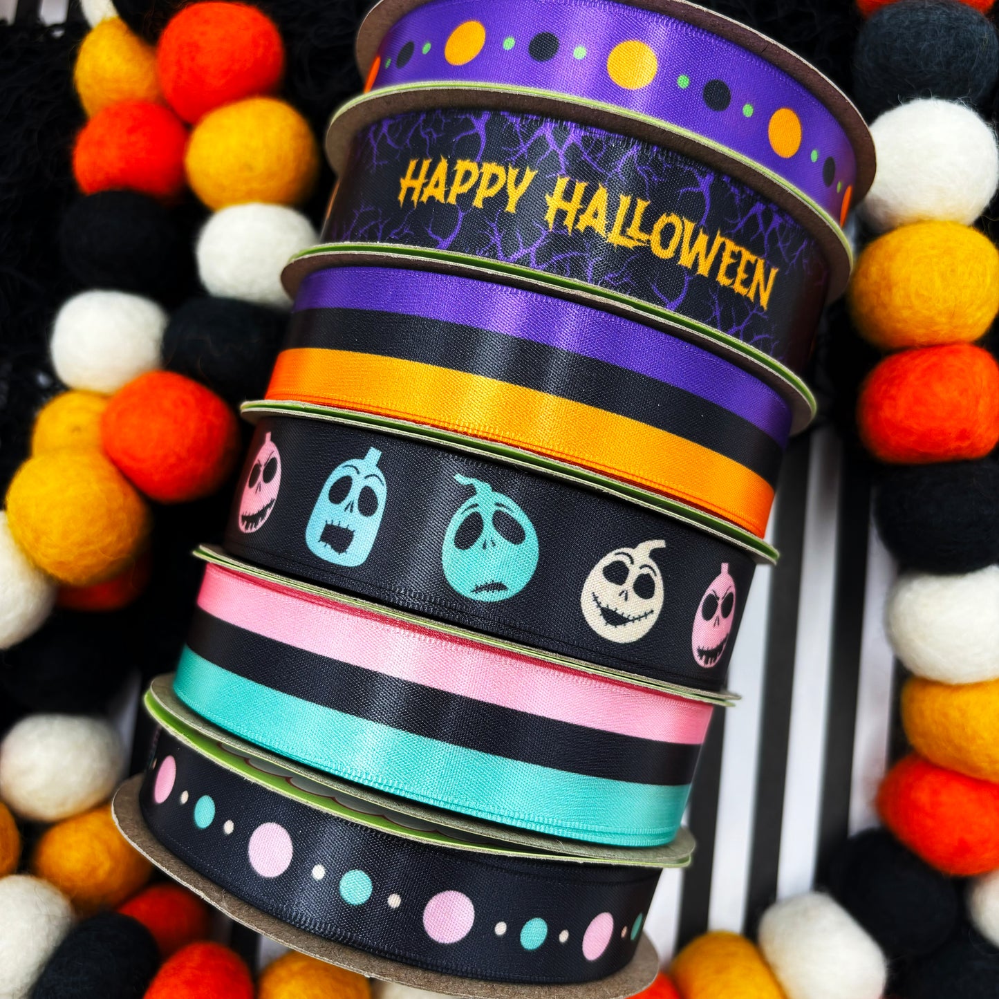 Happy Halloween Ribbon featuring Happy Halloween in orange on a black background with purple branches printed on 7/8" white satin