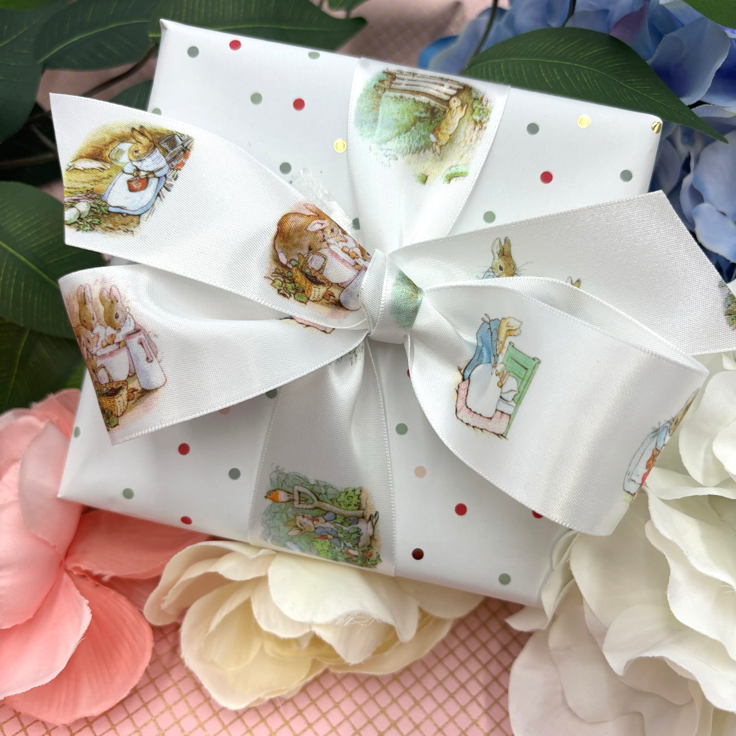 Bunny ribbon, rabbits in a blue jacket of storybook fame printed on 1.5" white satin and grosgrain