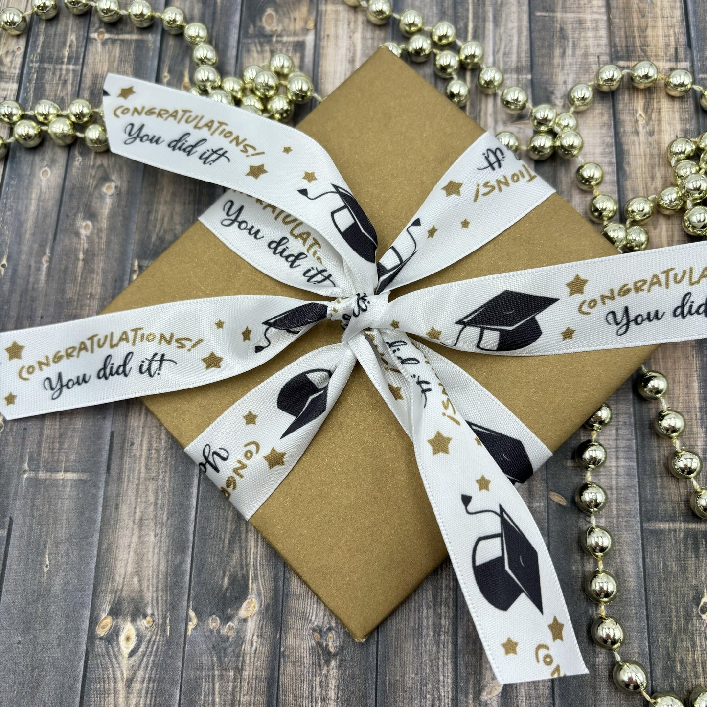 Graduation Ribbon You Did It printed in gold and black with gold stars printed on 7/8" white single face satin
