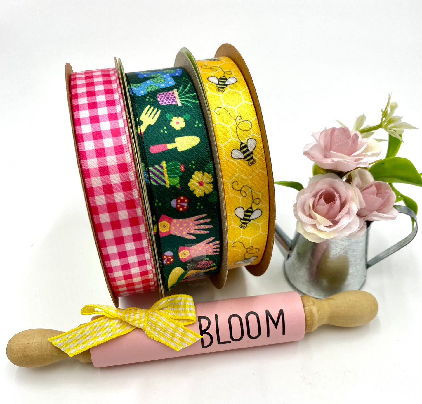 Gardening ribbon featuring plants, flowers, boots, hats, gloves and tools on a dark green background printed on 7/8" white satin