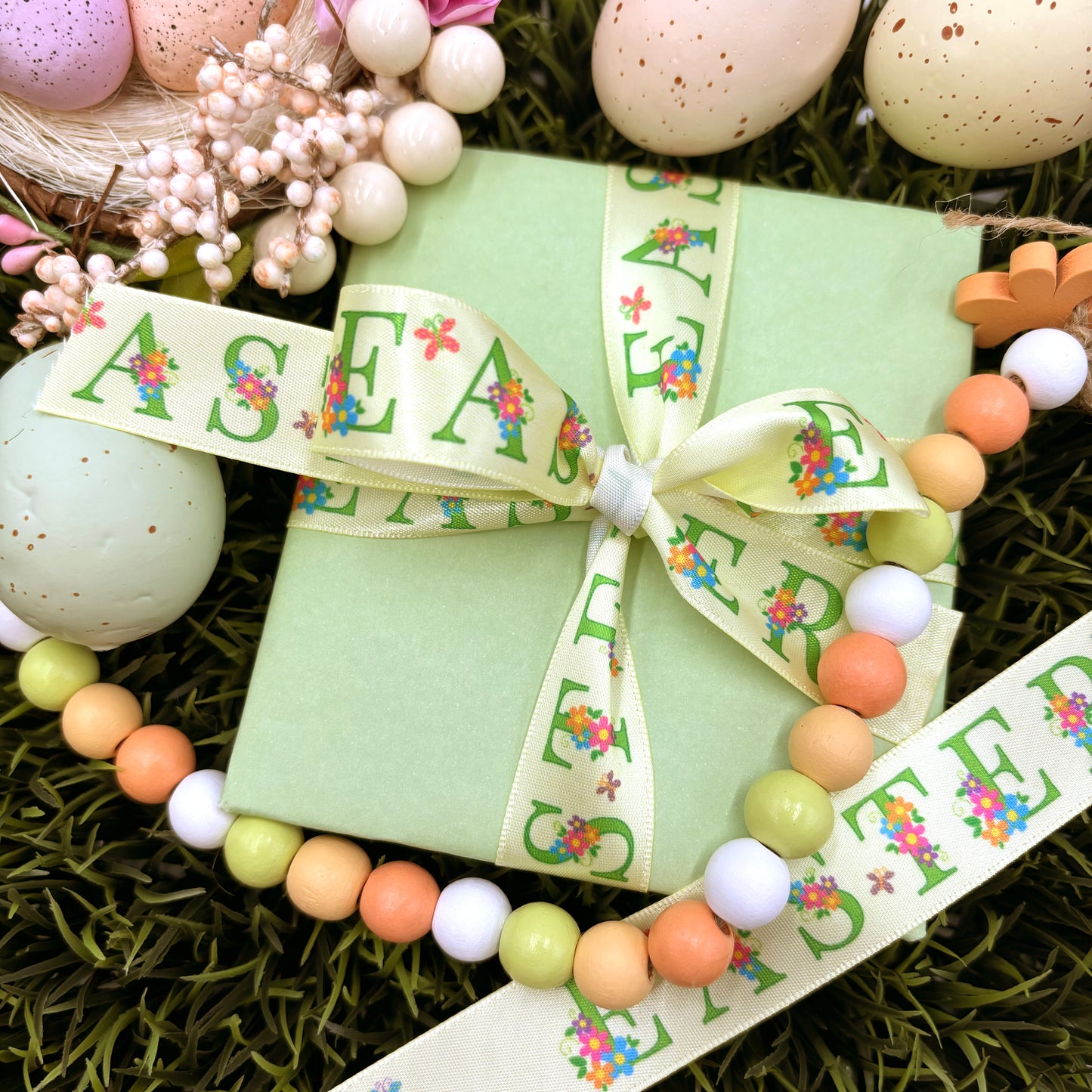 Easter ribbon Easter in green text decorated with Spring flowers on a yellow background printed on 5/8" and 7/8" white satin