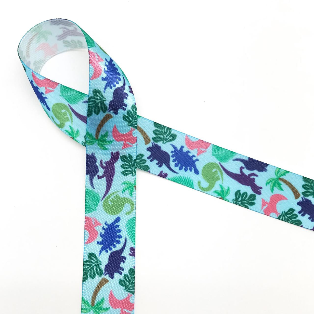 Dinosaur ribbon printed on 5/8" lt. blue ribbon incorporate all the creatures of the Jurassic age! There are Tyrannosaurus Rex, Triceratops, and Pterodactyls and more along with the leafy greens they loved to eat!