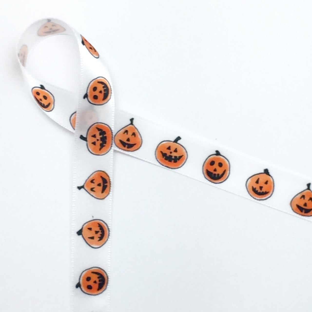 Pumpkin cuties in a row smiling and having fun on 5/8" single face satin White ribbon, 10 Yards