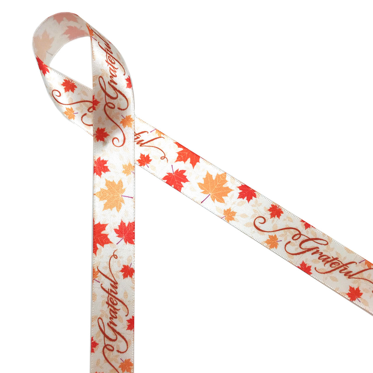 Grateful in a rust curly font with tossed Fall leaves of orange and gold printed on 7/8" antique white single face satin ribbon is an ideal ribbon for Thanksgiving gifts, table decor, wreaths and floral pieces. Be sure to have this ribbon on hand for your Thanksgiving needs. Our ribbon is designed and printed in the USA