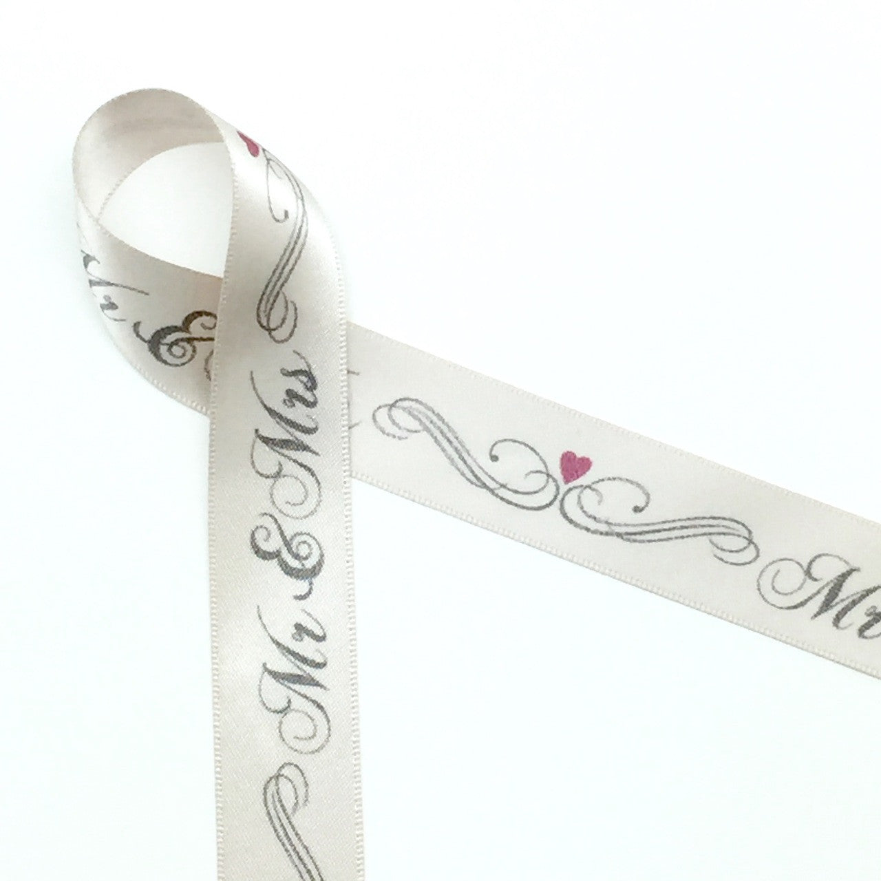Mr. & Mrs. with scrolls and hearts on 7/8" double face satin ribbon on 10 yard spools. Designed and printed in the USA