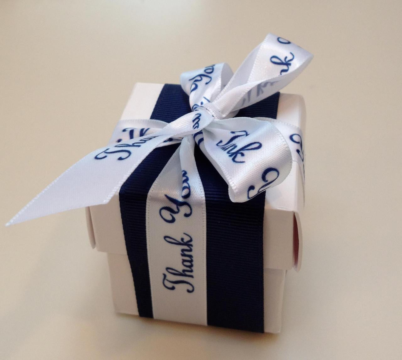 This favor box is dressed up formally! A band of navy grosgrain ribbon is adorned with our navy and white satin Thank You ribbon. Perfect for an elegant statement at the end of a beautiful evening!