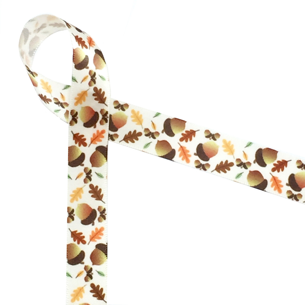 Acorns tossed with colorful oak leaves on a 5/8" antique white single face satin bring forth all the wonderful memories of Fall! This lovely ribbon can be used for party favors, floral design, gift wrap, gift baskets, table decor, cookies, cake pops and candy shops. This is a great ribbon for Fall crafts, quilting and sewing projects too. All our ribbon is designed and printed in the USA