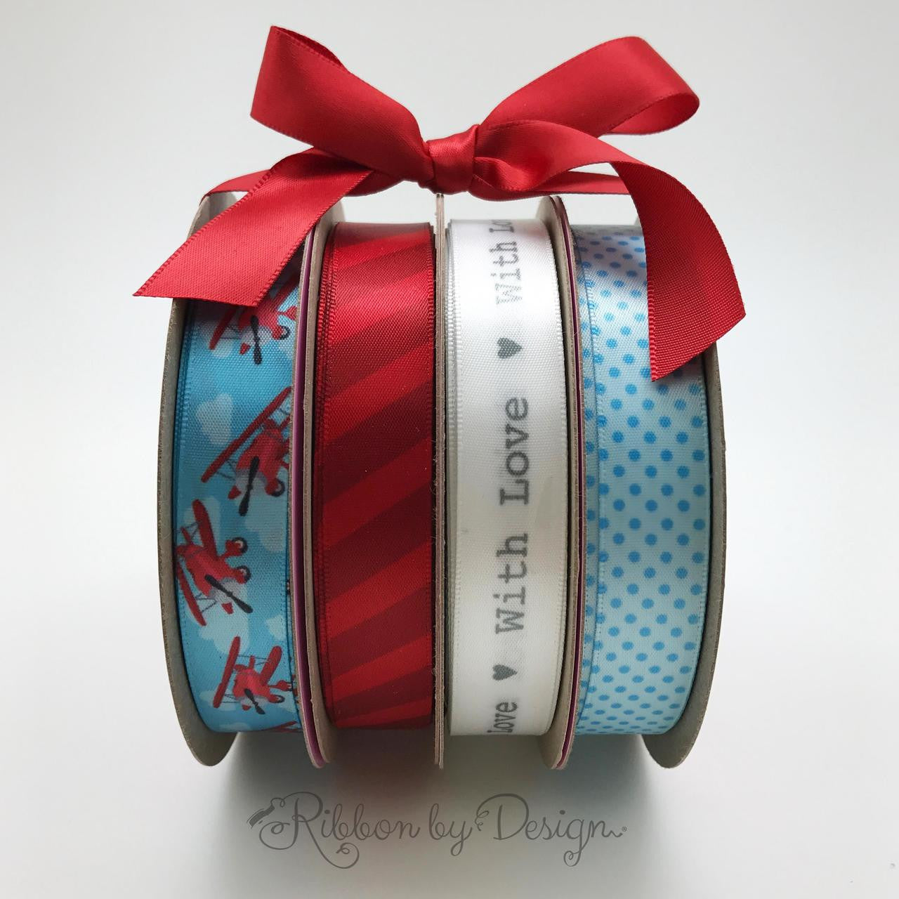 Combine our airplane ribbon with red stripes and light blue pin dots to complete the decor of a party. Add our "With Love" ribbon for favors at a shower or reveal party!