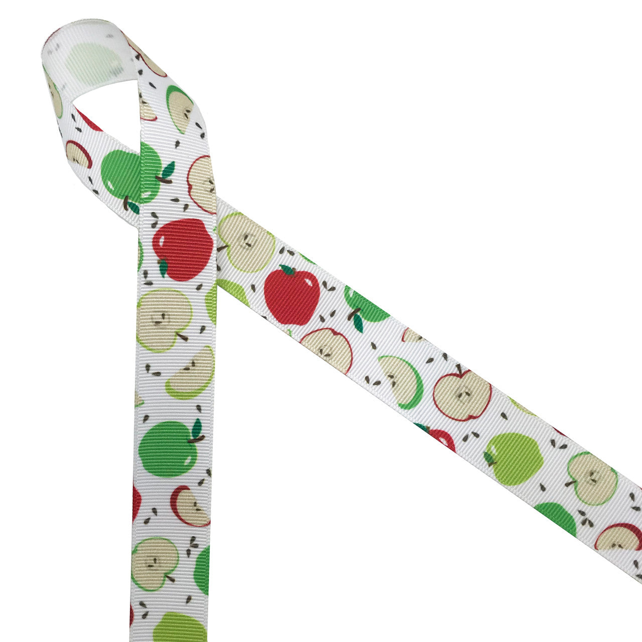 Green and red apples with brown seeds and apple slices printed on 7/8" white grosgrain ribbon is such a fun ribbon for Fall crafting! A great choice for hair bows, scrap booking and more! Designed and printed in the USA