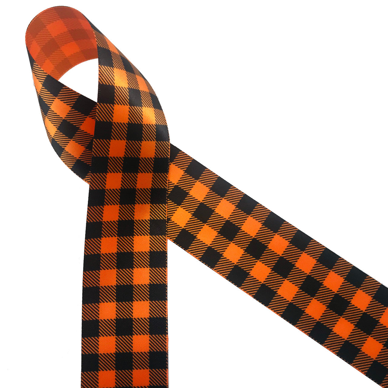 Black plaid printed on 1.5" tangerine single face satin ribbon is the ideal ribbon for all your Fall decor, crafting and gift ideas. Be sure to have this ribbon on hand for occasions from Halloween to Thanksgiving! Designed and printed in the USA