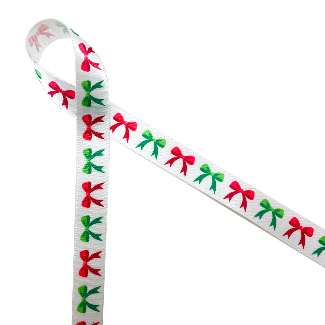 Christmas bows in red and green line up along a 5/8" white single face satin ribbon for Holiday gift wrap, gift baskets, cookies, chocolates and candy. This adorable ribbon is perfect for party favors, table decor, hair bows, crafts and quilting. All our ribbon is designed and printed in the USA