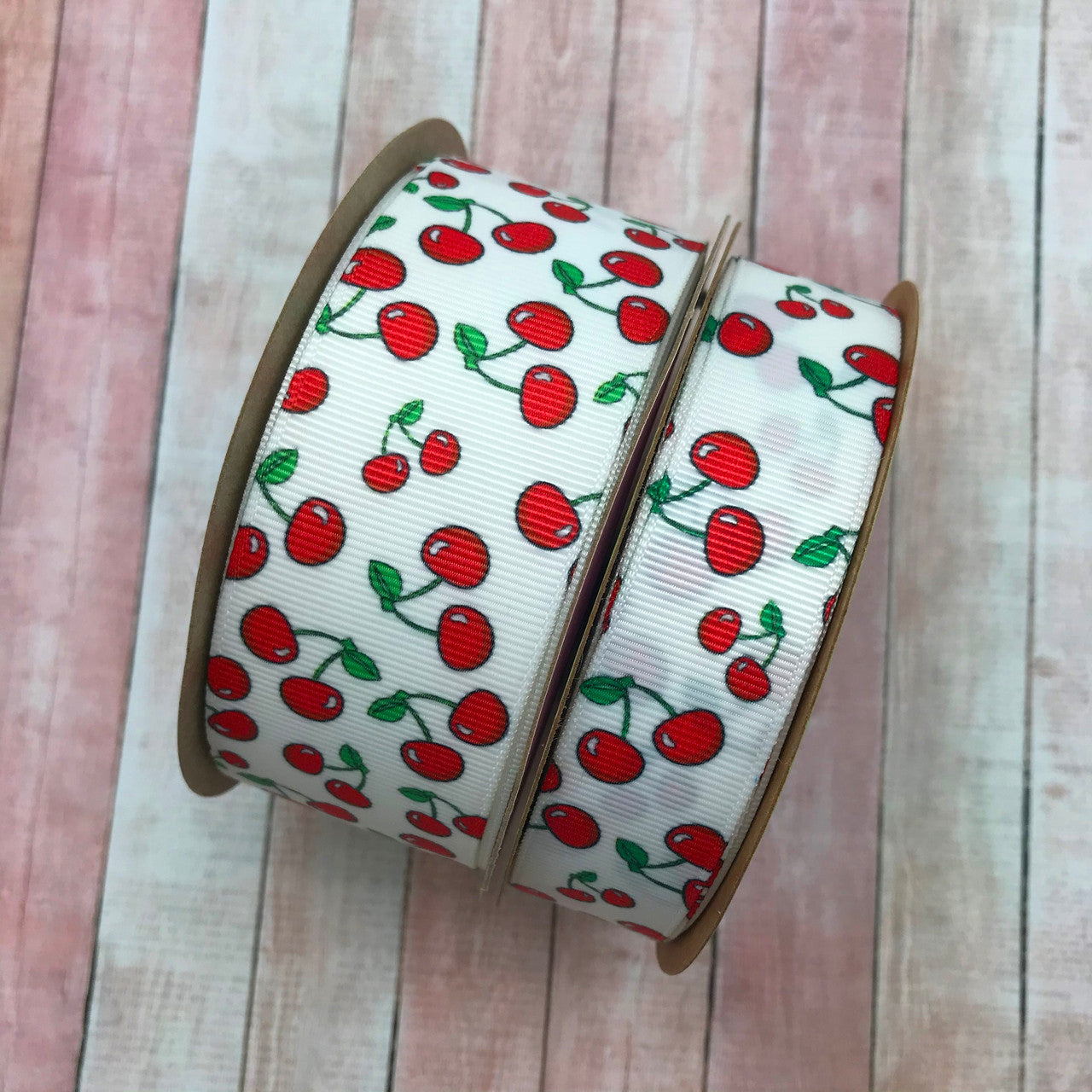 Our Cherries  ribbon comes in two sizes on white grosgrain! We have 1.5" and 7/8" for larger and smaller projects!