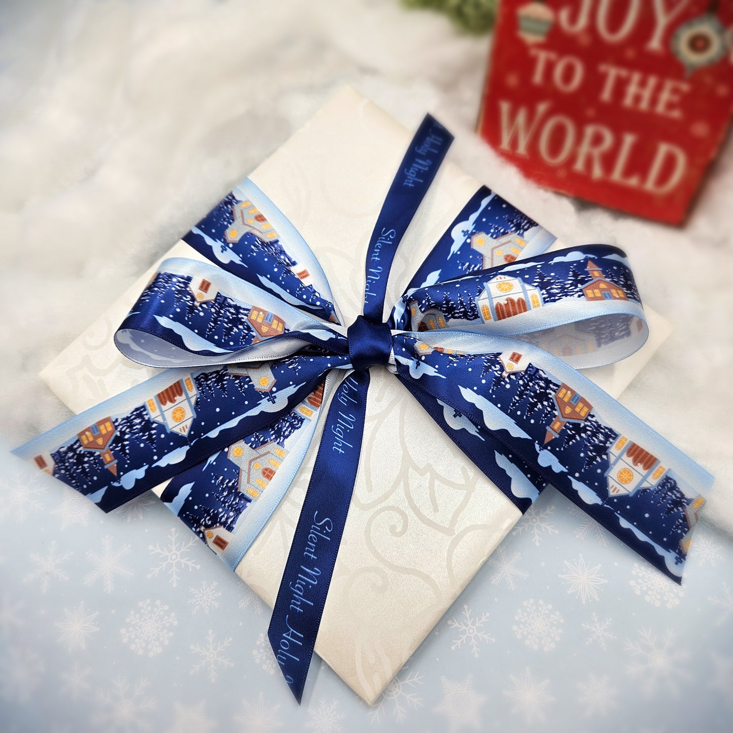 Churches in the snow on a navy blue background with pine trees and snowfall printed on 7/8 and 1.5" white single face satin