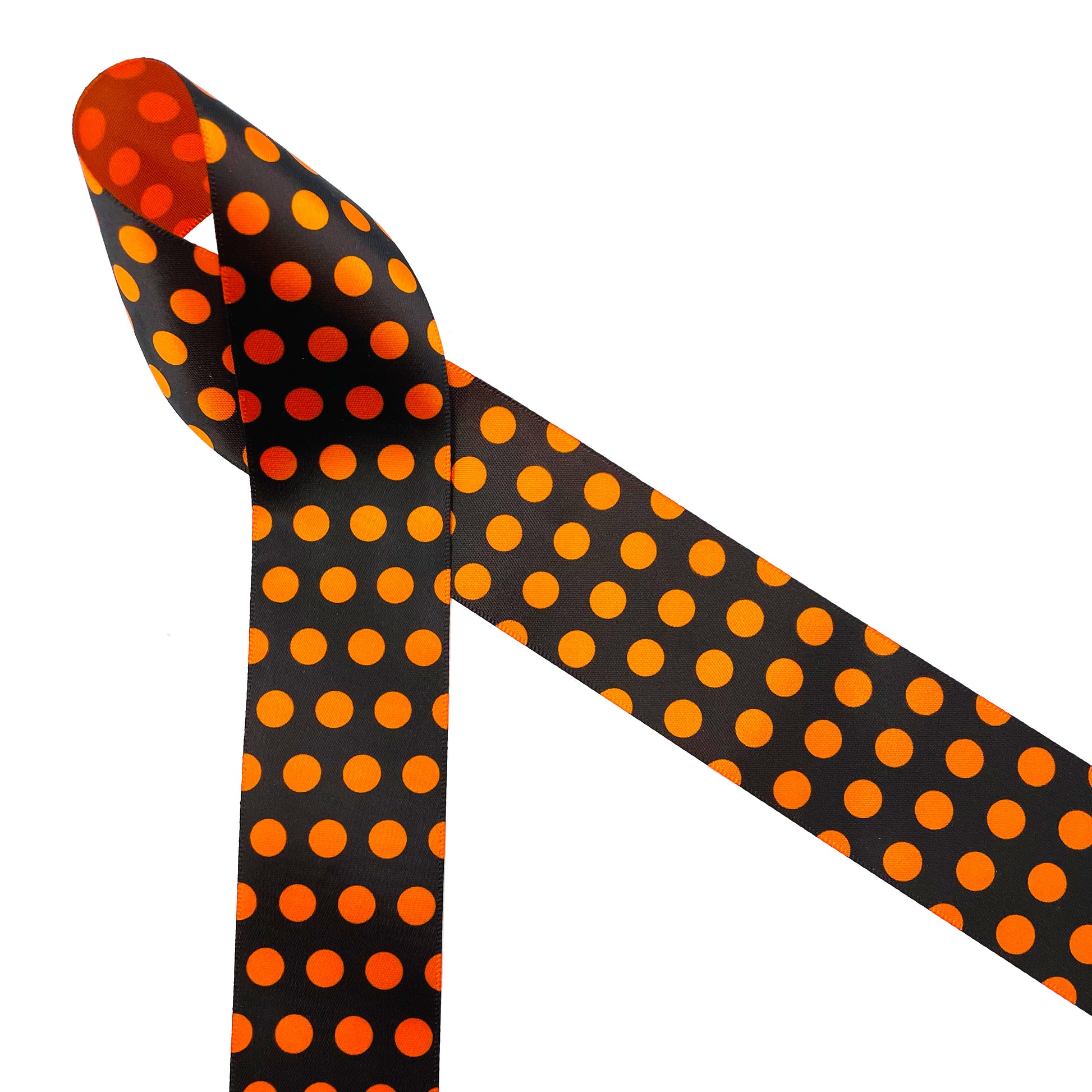 Nothing says Halloween like black and orange dots! Orange polka dots on a black background printed on 7/8" orange satin ribbon is a Halloween tradition. This Halloween classic design is ideal for party decor, party favors, gift wrap, gift baskets, treat bags, candy shops, bakeries, cookies and cake pops! This is a great design for Halloween crafts, wreaths, sewing and quilting projects. All our ribbon is designed and printed in the USA