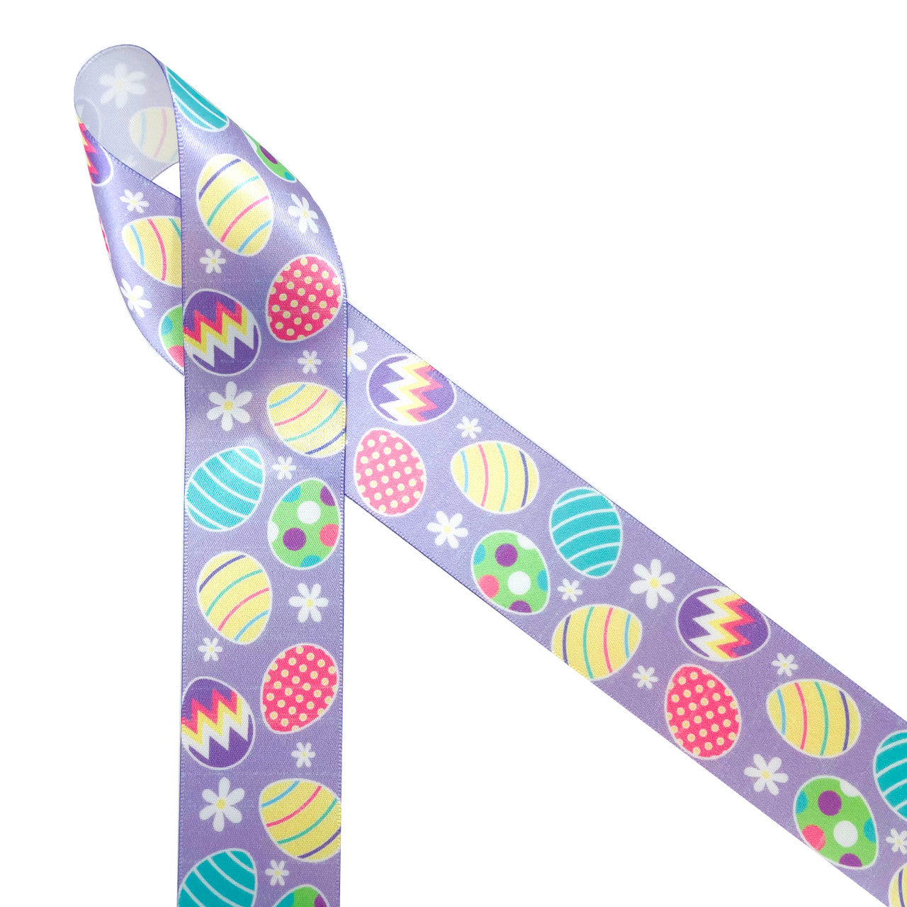 Easter eggs on a lavender background with tossed with daisies in pastel colors of pink, yellow, green, coral and blue printed on 1.5" white single face satin ribbon is the perfect ribbon for all your Easter gifts, crafts, floral designs and sewing projects. Be sure to have this ribbon on hand for Easter baskets too! All our ribbon is designed and printed in the USA