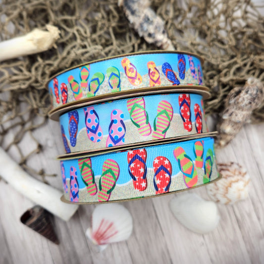 Flip Flop ribbon colorful flip flops in stripes, stars, and floral designs on a sand and blue background printed on  5/8" and 7/8" white single face satin and grosgrain