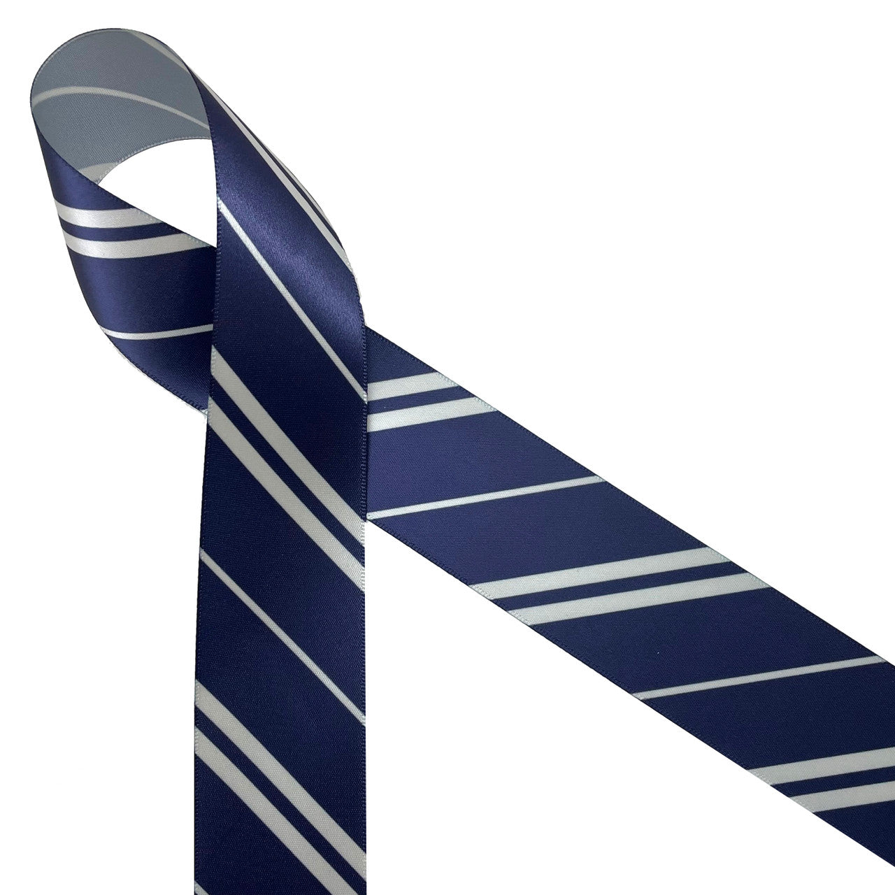 Ravenclaw wide and narrow stripes of gray and navy blue printed on 7/8" gray single face satin ribbon is an ideal addition to any Hogwarts themed party!  Use this ribbon for Christmas tree trim, party decor, gift wrap. gift baskets,. baby showers, crafts, sewing and quilting projects too. All our ribbon is designed and printed in the USA