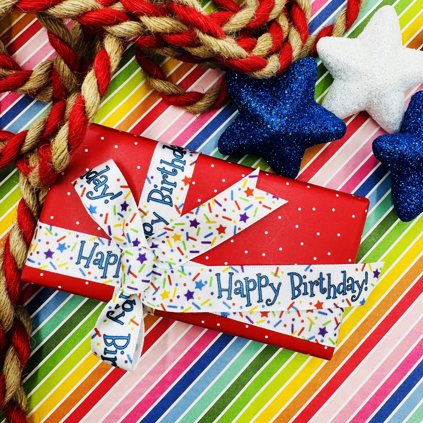 Happy Birthday ribbon with sprinkles and stars confetti in primary colors printed on 5/8" and 7/8" white satin