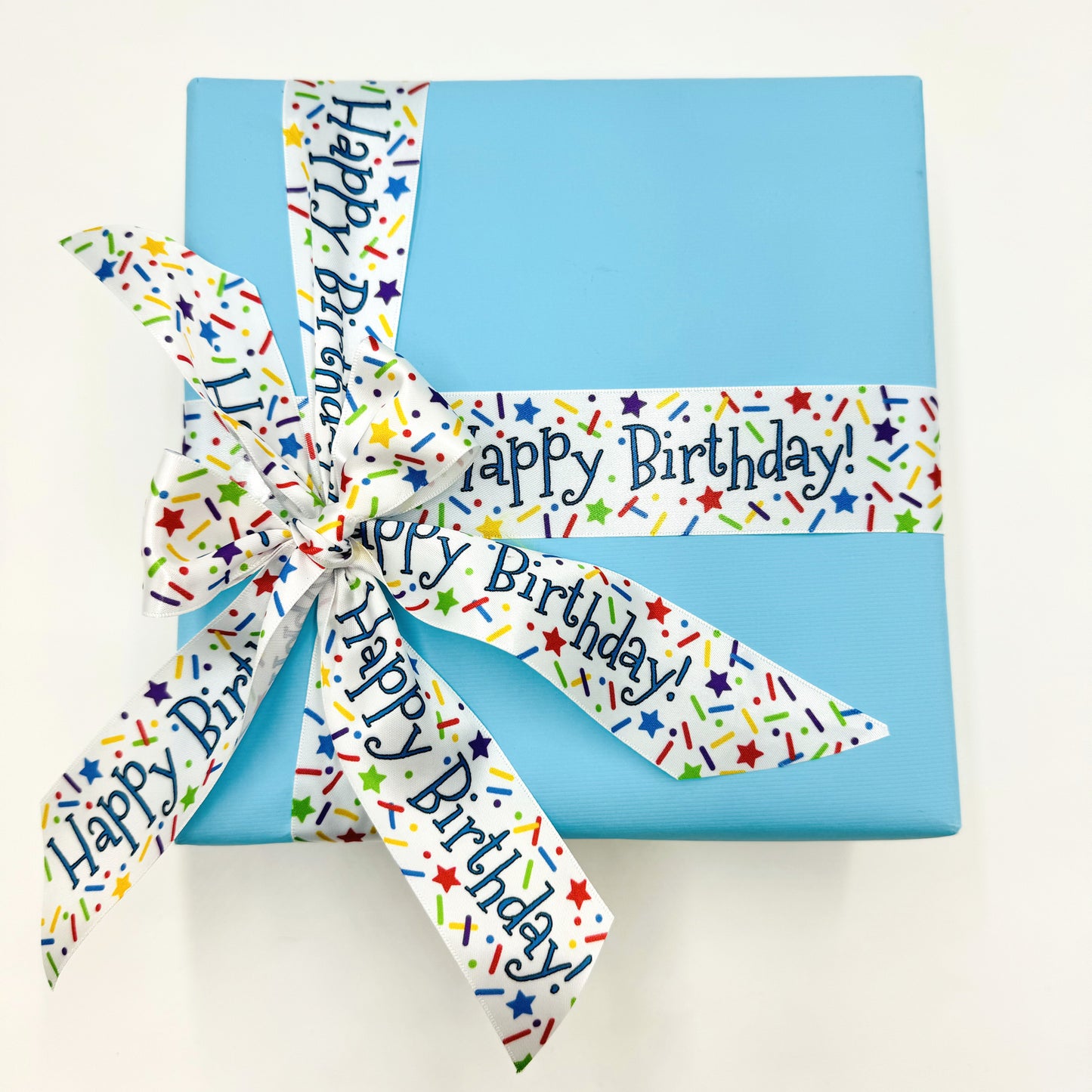 Happy Birthday ribbon with sprinkles and stars confetti in primary colors printed on 5/8" and 7/8" white satin