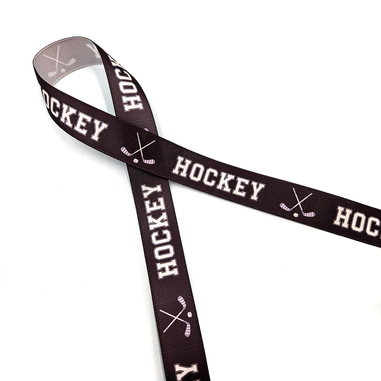 Hockey Ribbon with crossed Hockey sticks in white on a black background printed on 5/8" and 7/8" white satin