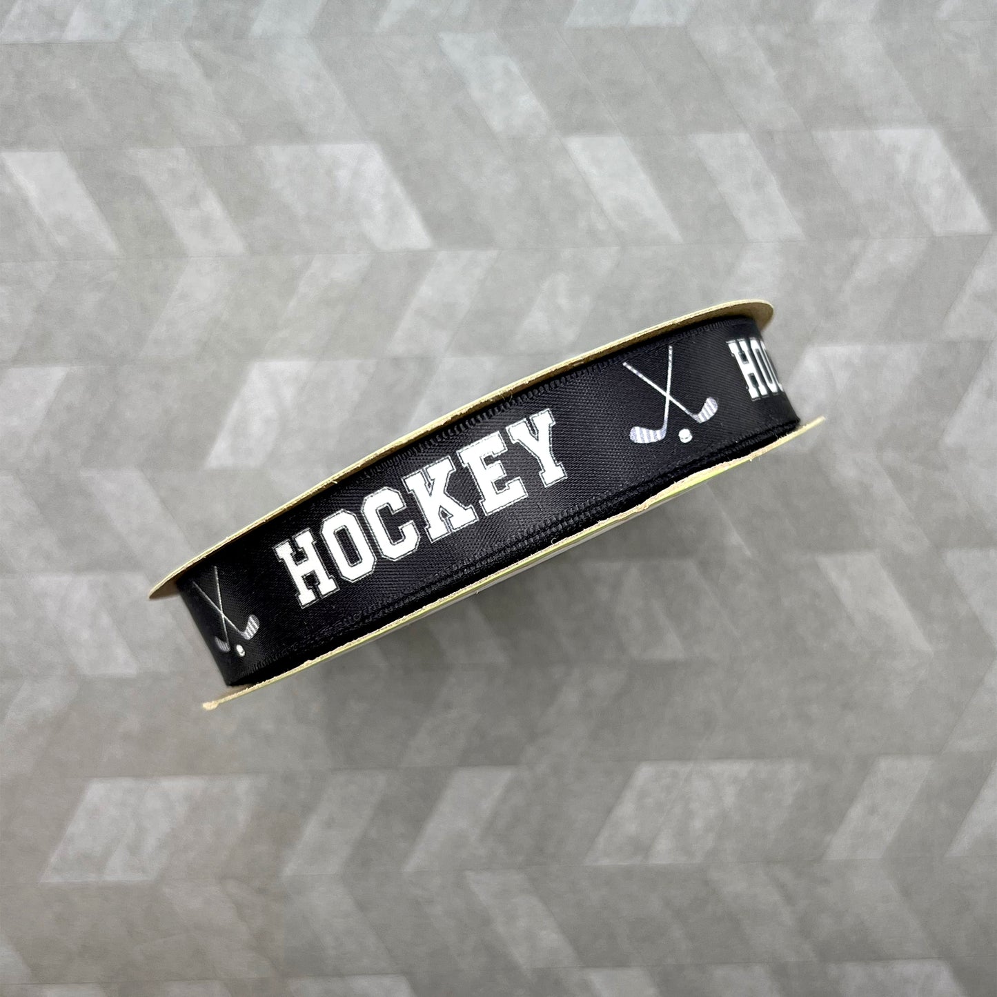 Hockey Ribbon with crossed Hockey sticks in white on a black background printed on 5/8" white satin