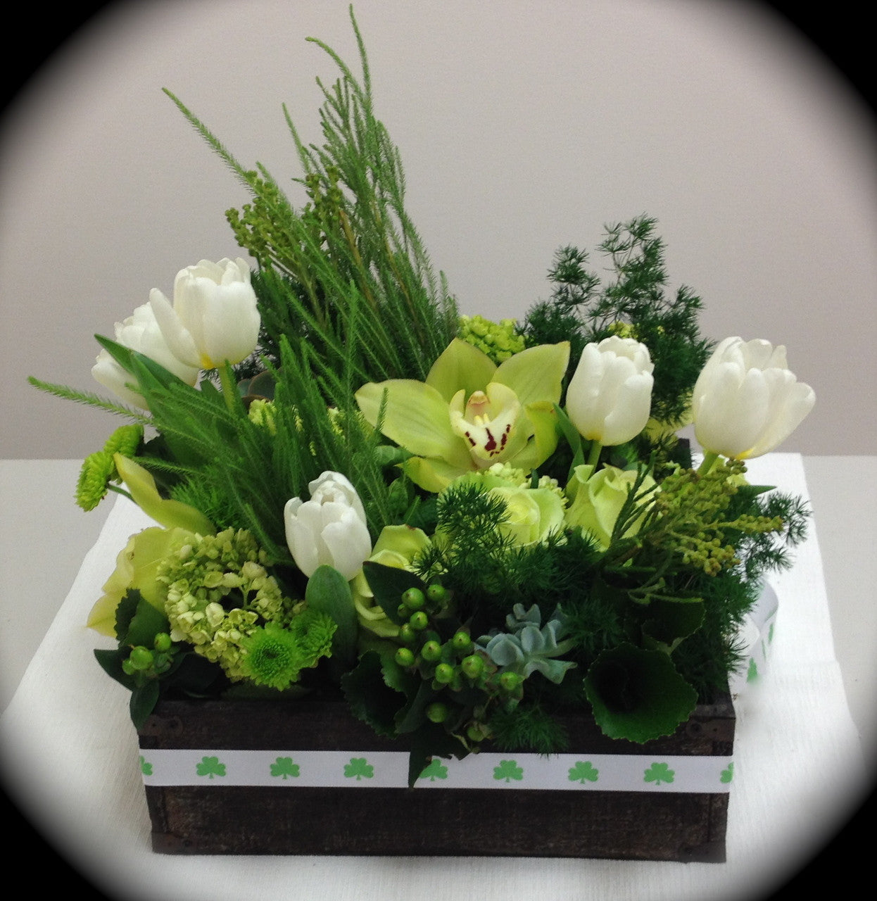 Our shamrocks add just the right touch to this green and white floral arrangement to make it a special delivery for St. Patricks Day!