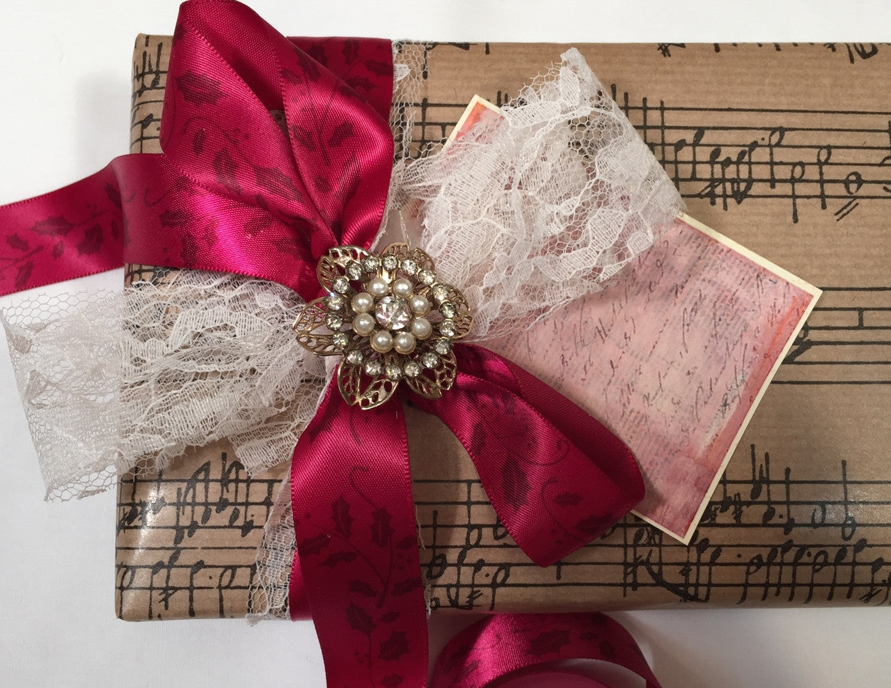 Add a little lace and antique brooch to a package with our ribbon and you have a little romance!