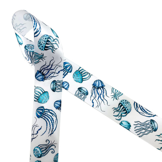 A variety of jelly fish in shades of blue printed on 1.5" white single face satin ribbon is an ideal ribbon for beach and ocean themed events and weddings. This beautiful ribbon is ideal for gift wrap, gift baskets, table decor, party decor, floral design, crafts and quilting. Be sure to have this ribbon on hand for Summer crafts,  scrap books, hair bows and head bands too. All our ribbon is designed and printed in the USA