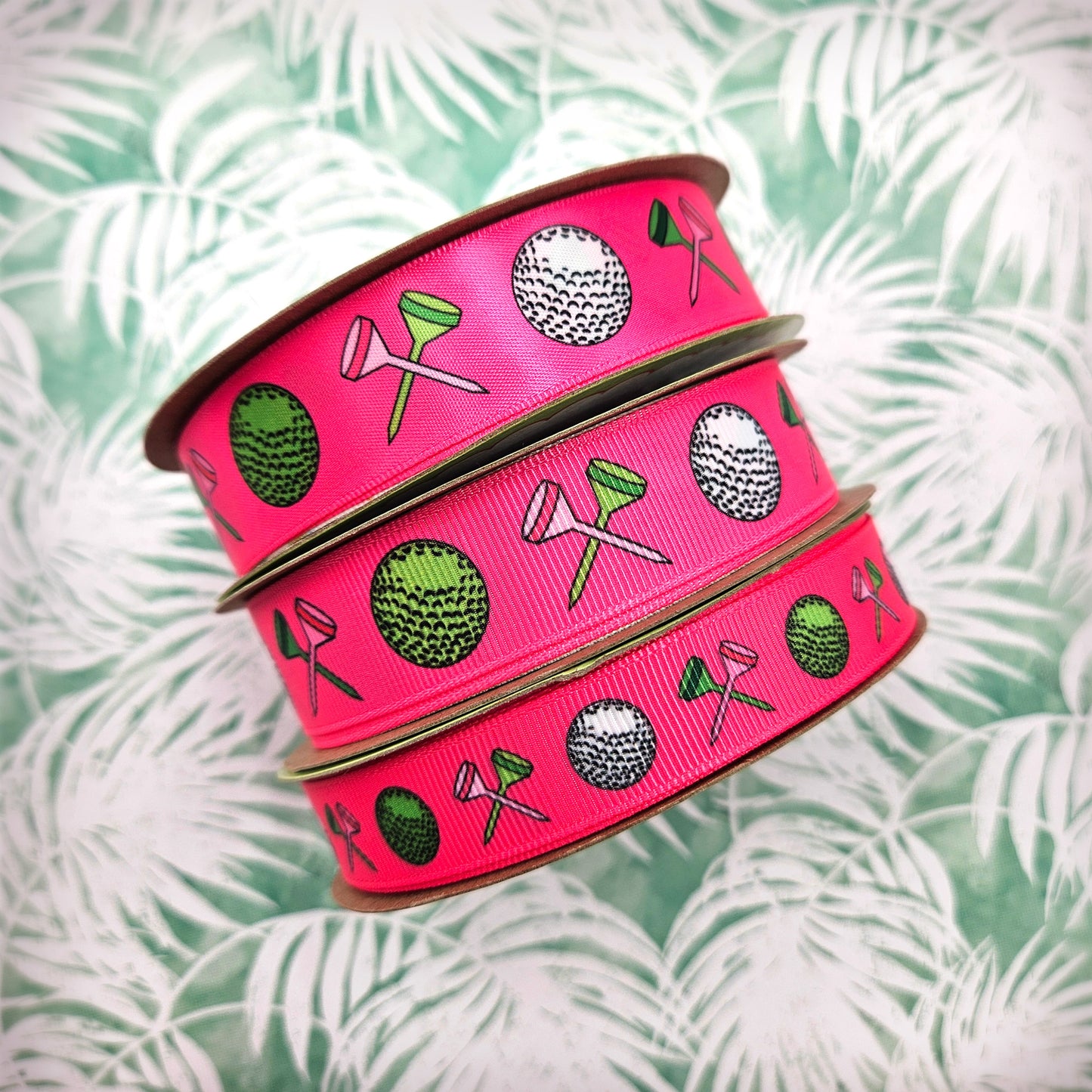 Golf ribbon Women's golf featuring golf balls and crossed tees on a hot pink background printed on 5/8" and 7/8" white grosgrain or white satin