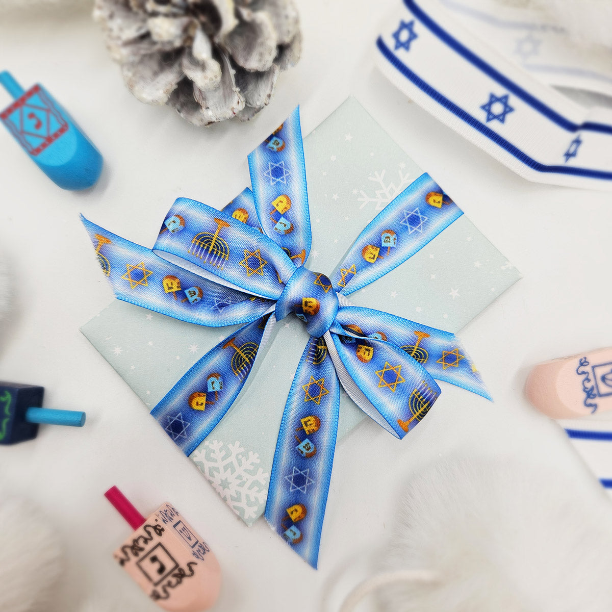 Hanukkah Ribbon in shades ofLight  blue with Menorahs, dreidels and Star of David in a row for gifts printed on 5/8" and 7/8" white satin