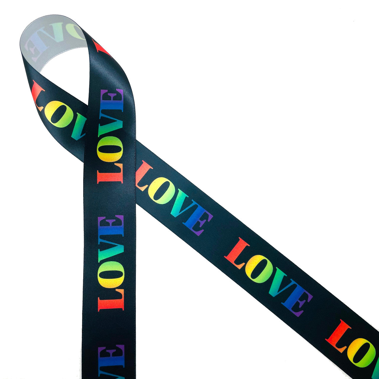 Love in Rainbow colors on a black background printed on 1.5" white single face satin  ribbon is an ideal ribbon for Valentine's Day, Galentine's Day, Pride Week,  and LBGTQ celebrations because love is love. This ribbon is perfect for gift wrap, party decor, wreaths, floral design, quilting and crafts. All our ribbon is designed and printed in the USA