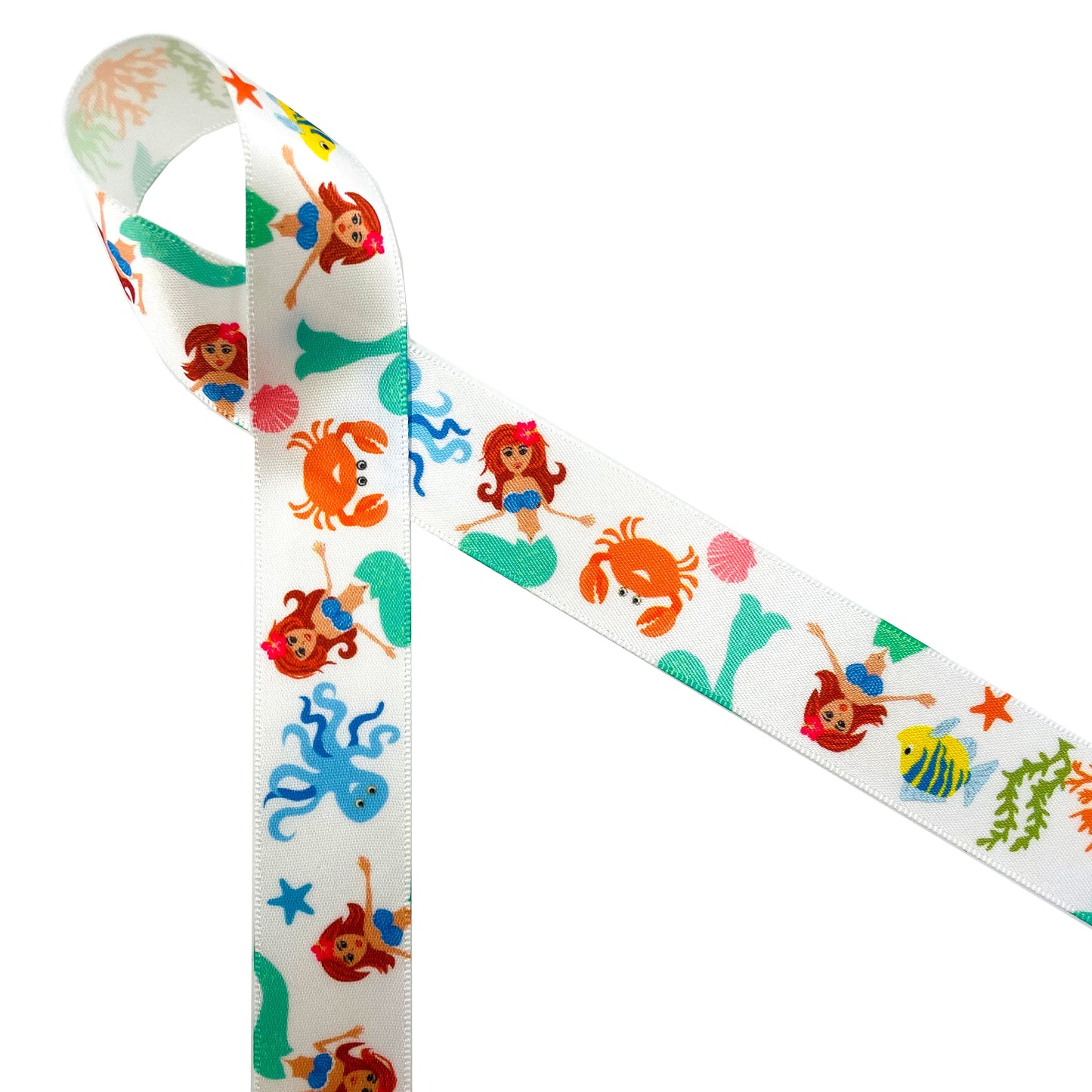 Mermaids with red flowing hair sit among sea creatures including crabs, tropical fish, octopus, star fish and coral reef printed on 7/8" white single face satin ribbon. This lovely ribbon is perfect for birthday parties, pool parties, beach parties and Summer theme parties. Use this ribbon for gift wrap, gift baskets, party decor, party favors, cookies and cake pops. This is a great ribbon for hair bows, head bands, quilting and sewing projects too. All our ribbon is designed and printed in the USA