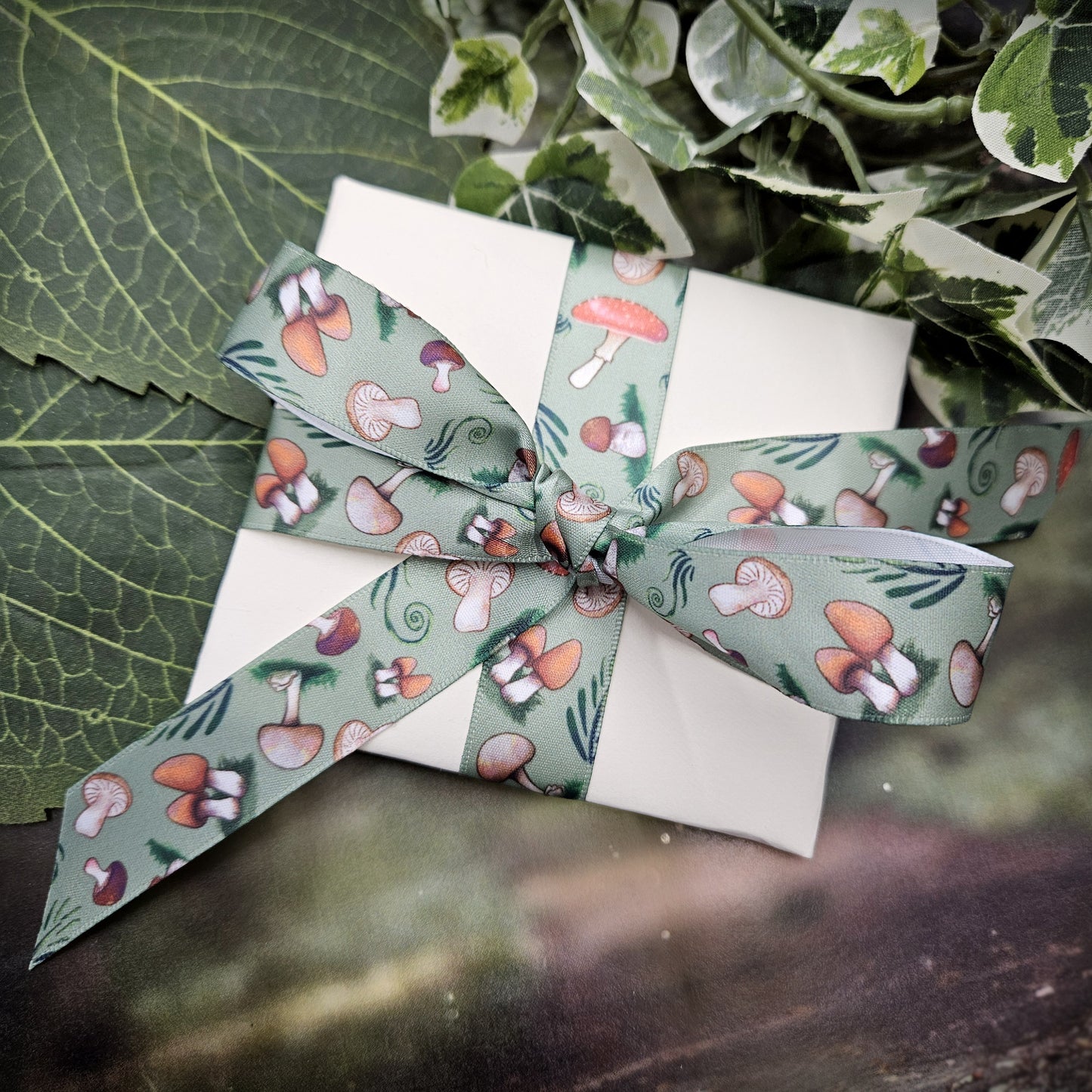 Mushroom ribbon with a variety of mushrooms tossed with forrest fern and flora printed on 7/8" white single face satin