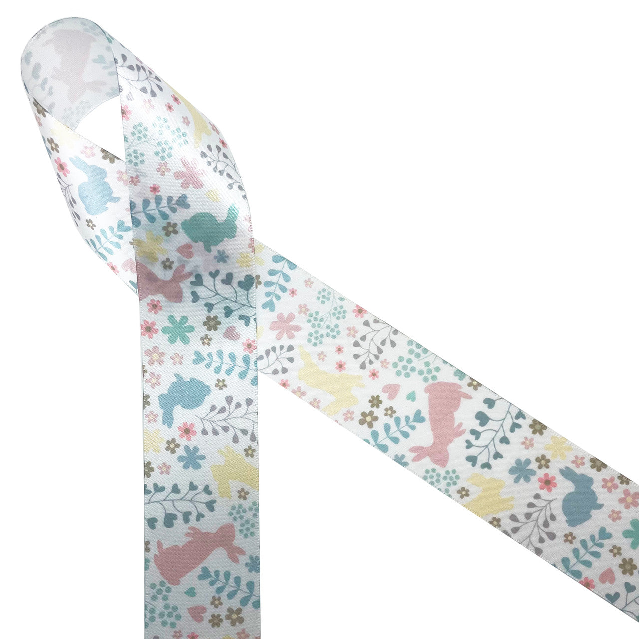 Pastel bunnies in blush pink, yellow, and teal are tossed with floral and fern printed on 1.5" white single face satin ribbon. This soft palette is perfect for Easter wreaths, Easter baskets, Easter floral designs, Spring wreaths, table decor, quilting and sewing. Be sure to  have this ribbon on hand for all your Spring  crafts. All our ribbon is designed and printed in the  USS