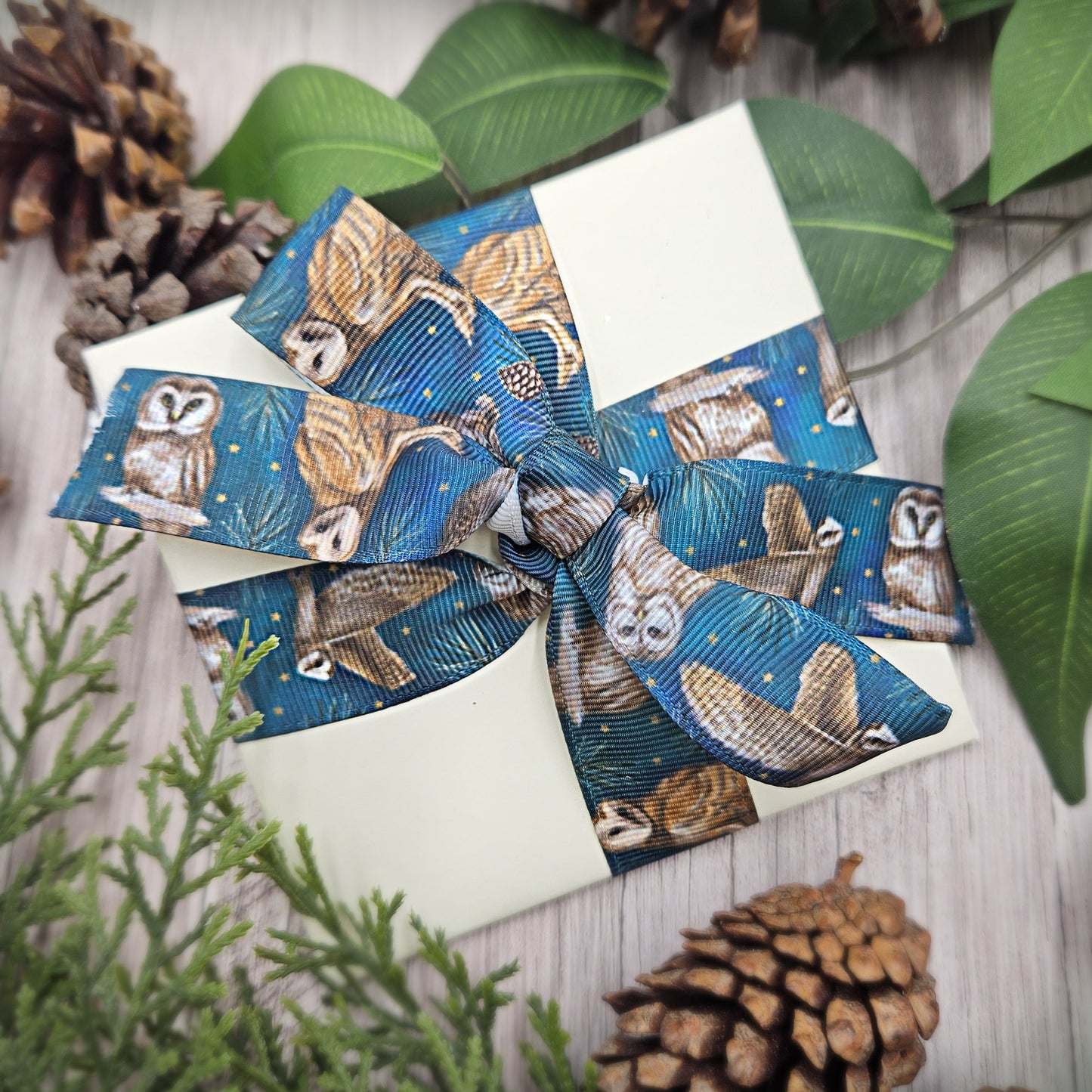 Owl ribbon artful owls on a teal blue background with gold stars and pine branches printed on 5/8" and 1.5" white satin