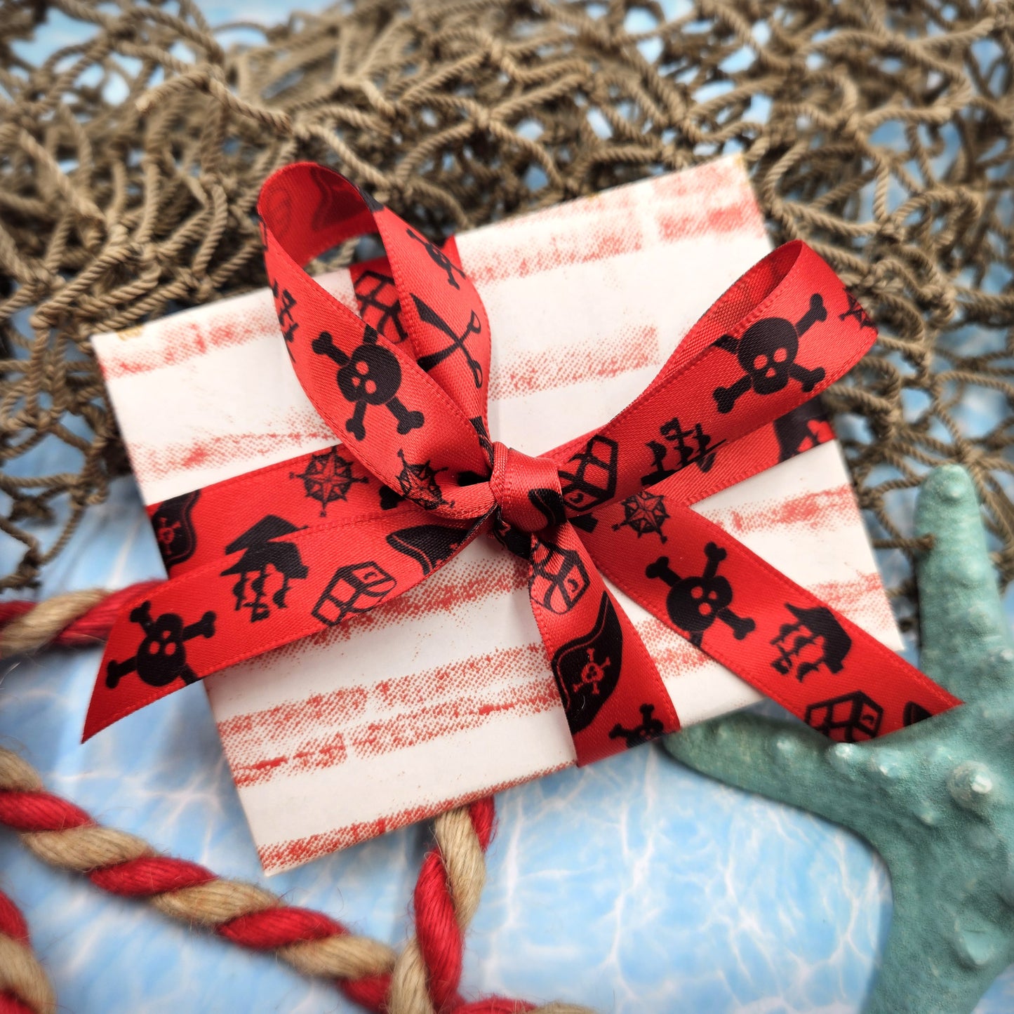 Pirate Ribbon silhouettes in black on 5/8" red single face satin ribbon